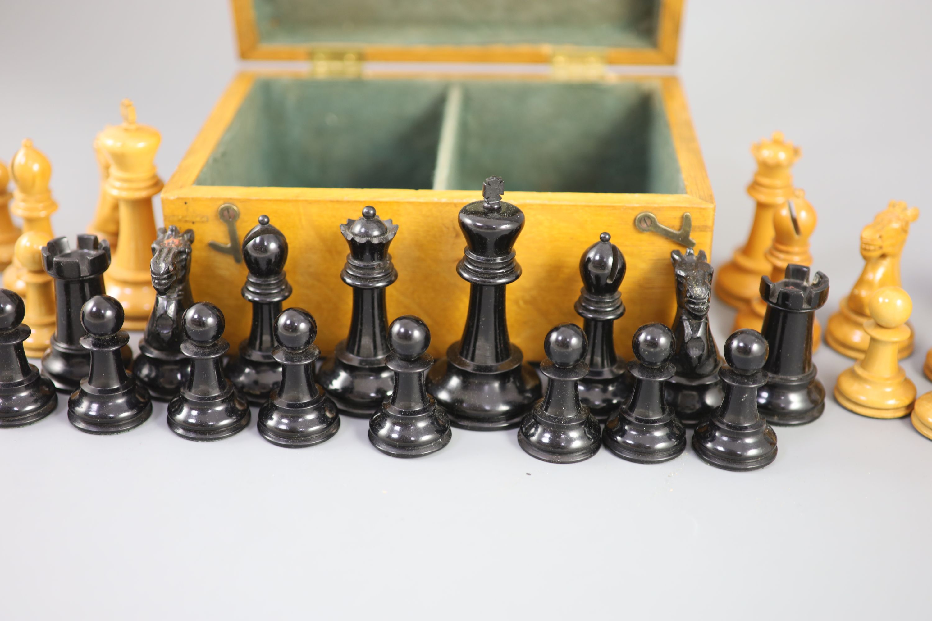 A Jaques & Son Staunton 3 1/2 boxwood and weighted chess set in original golden oak box, c.1910, 8 x 5.75 x 3.5in.